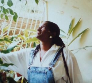 Side profile of Ava surrounded by plants