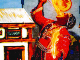 Tunka Abdurama placing a rod lit with fire in his mouth and holding fire in his hands
