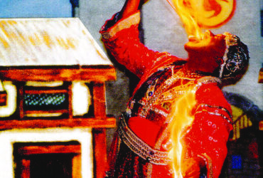 Tunka Abdurama placing a rod lit with fire in his mouth and holding fire in his hands