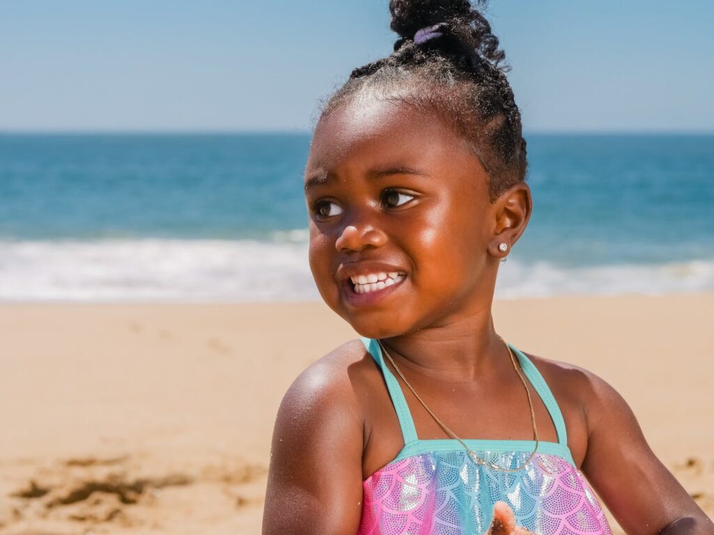 child smiling on the shore