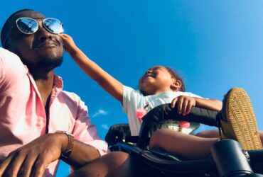 child playing with father's cheek