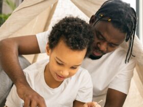 father teaching child to read