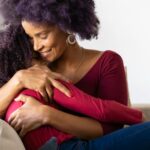 mother hugging daughter