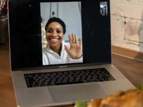 showing a computer screen with a woman waving