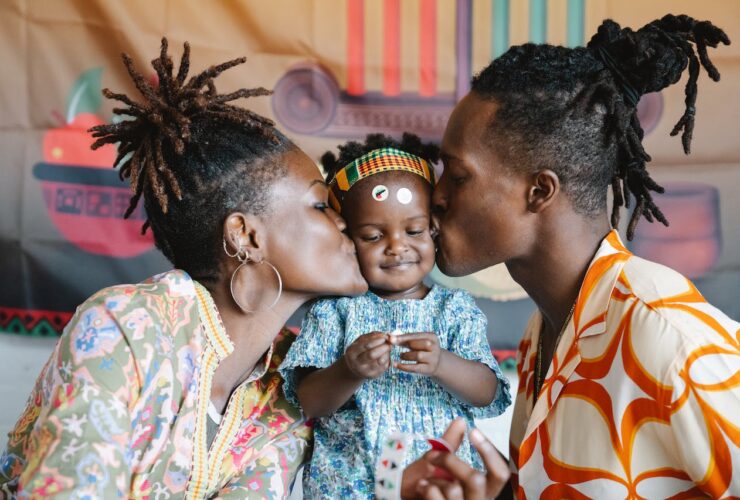 mother and father kissing their child