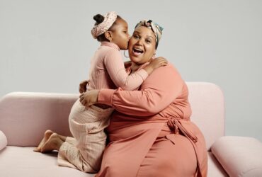 daughter kissing mother