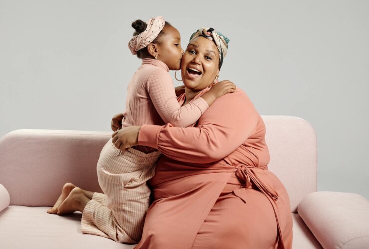 daughter kissing mother